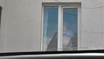 Sexy MILF Frina in dressing gown without panties and bra washes windows of apartment and is not shy about random taxi driver on street who looks out from his car. Naked in public. Nude in public. Public nudity. Publicly. Public. Natural tits Milf.