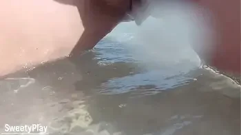 Shaved pussy peeing on public beach