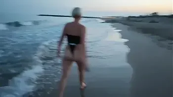 Blonde shows tits and sucks cock on a public beach