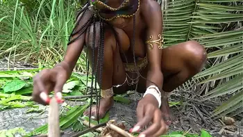 Hot African native woman cooking in the jungle