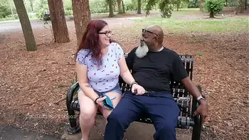Nerdy Milf strokes and suck blk dick in the Park