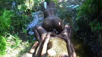 2 African tribe girls jerking off their chief with their asses in the river