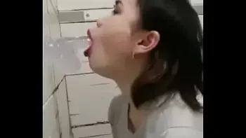Asian deepthroating a dildo