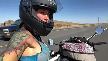 felicity feline riding on aprilia tuono motorcycle