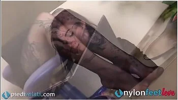 Under The Table, The Feet In Pantyhose Of The Tattooed Secretary