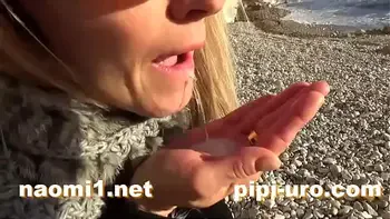 public pissing couple on a beach