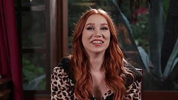 The red head Madison Morgan shows her assets in a captivating video