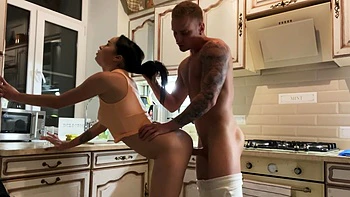 Brunette with long hair has sex in the kitchen
