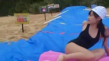 Two men finger her, give her a blowjob, and cum on her face.