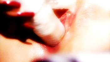 Glamorous doll with red lips Kitty Sixx plays with her shaved pussy