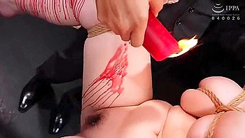 Wax is dripped on her and her big breasts are massaged and fingered before she is penetrated.